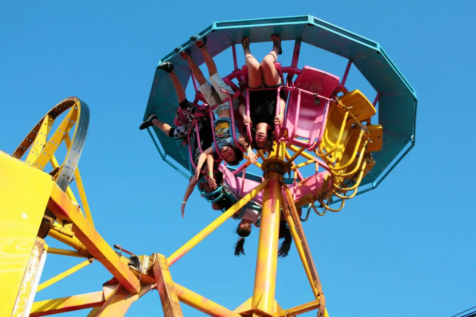 man in red jacket riding yellow and red roller coaster