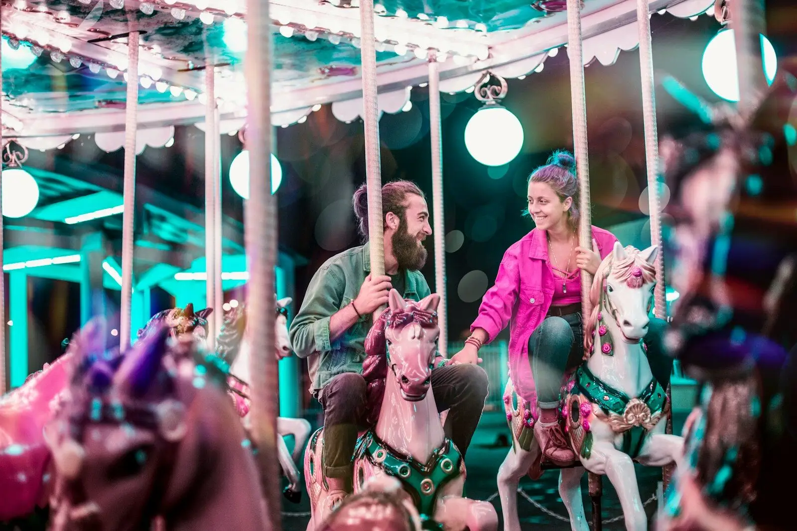 Merry-go-round with horses and decorative lights at night