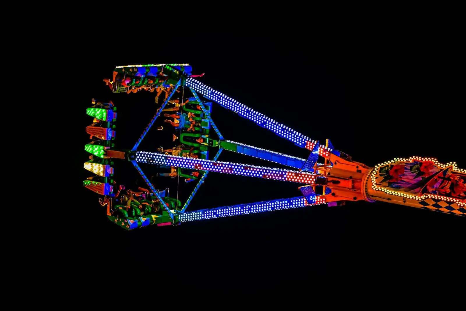 Amusement park ride with colorful lights at night