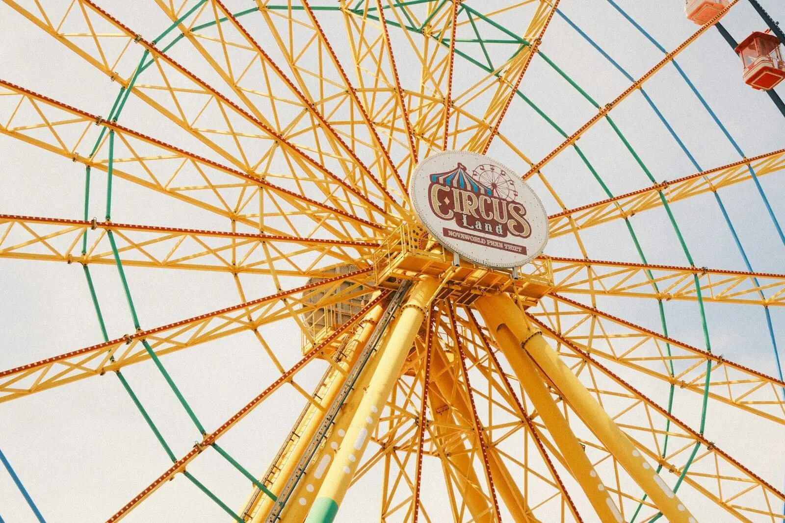 Yellow ferris wheel against a bright sky