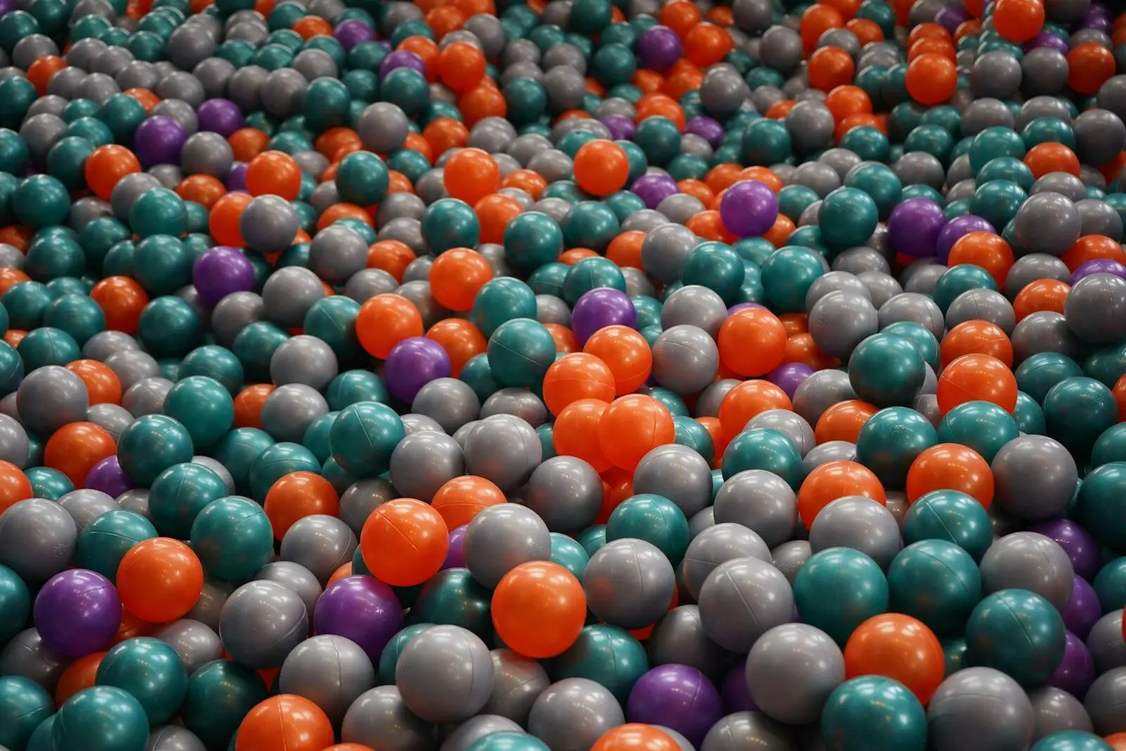A pile of colorful plastic balls in a ball pit