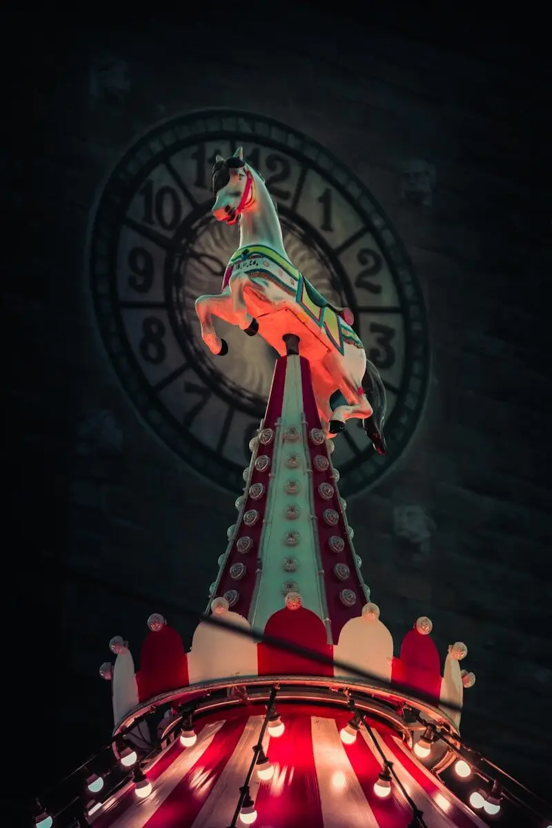 a carousel ride with a clock in the background