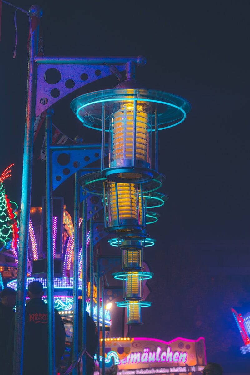 Row of illuminated carnival rides at night