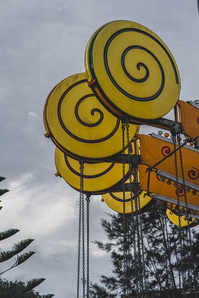 a large yellow sign hanging from the side of a building