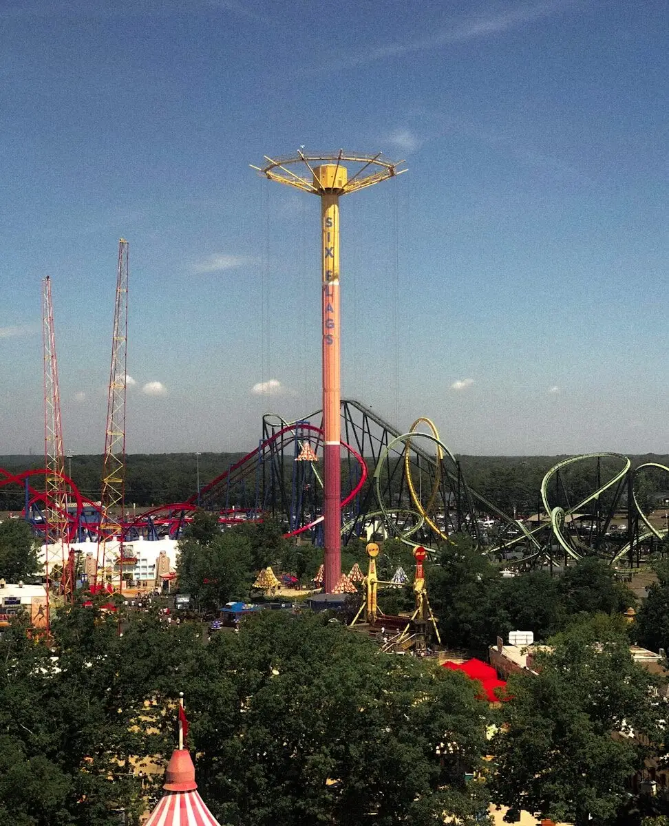 an amusement park with a ferris wheel and rides