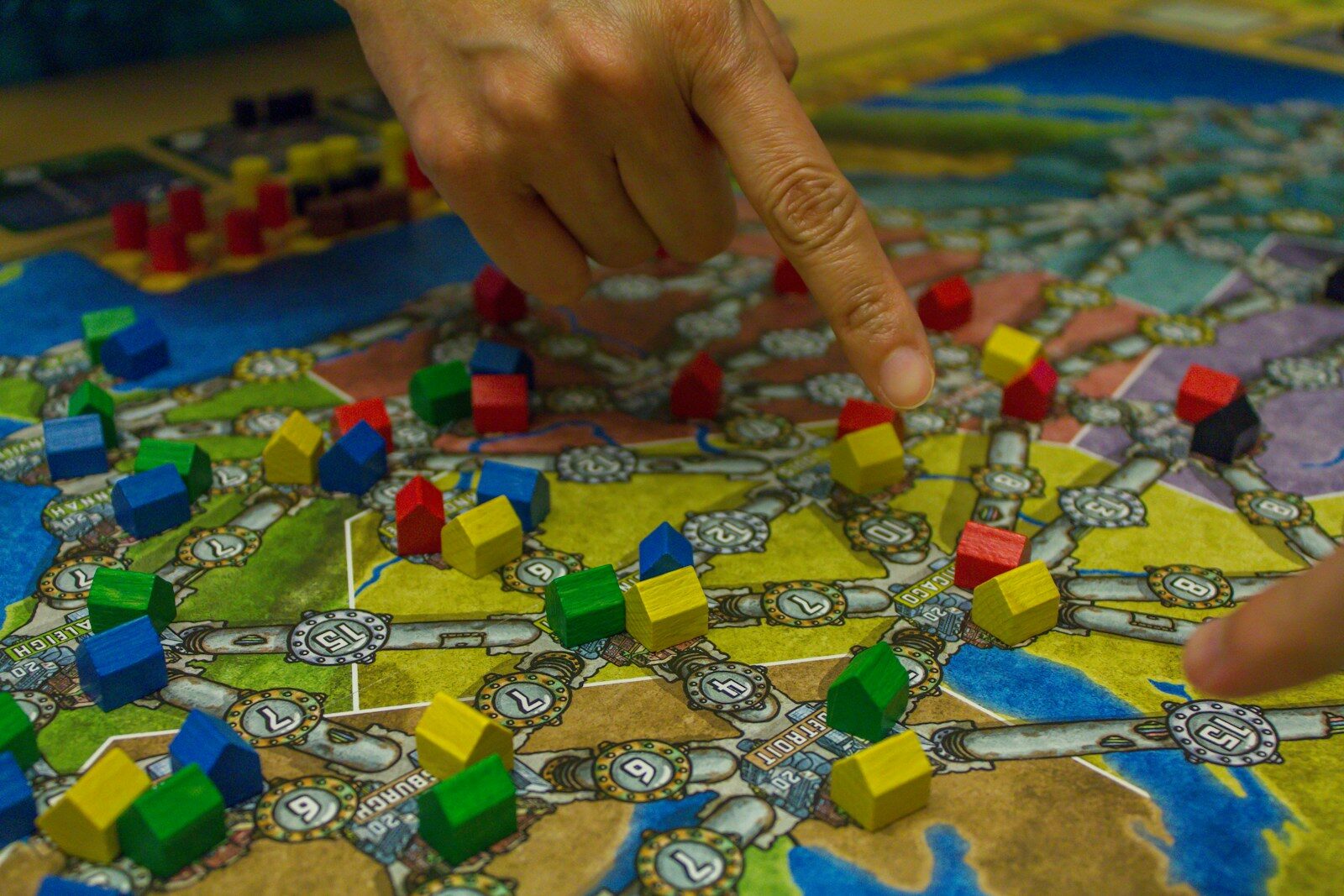 People playing a board game with colorful pieces