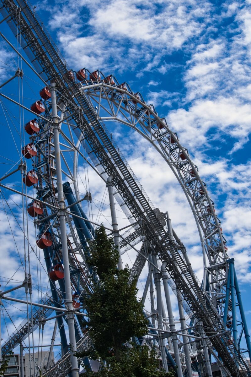 Ferris wheel against a cloudy blue sky