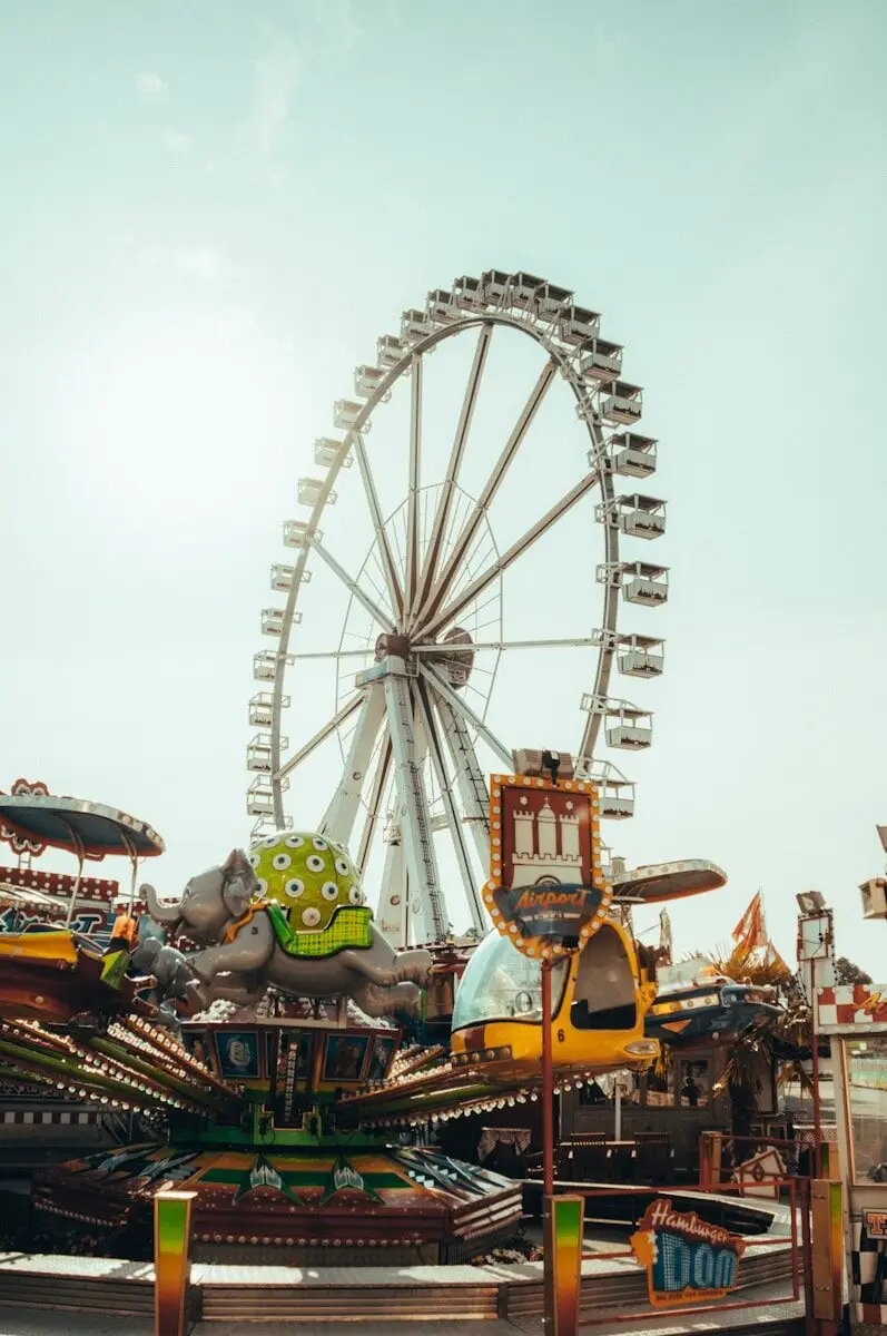 people riding on carousel during daytime