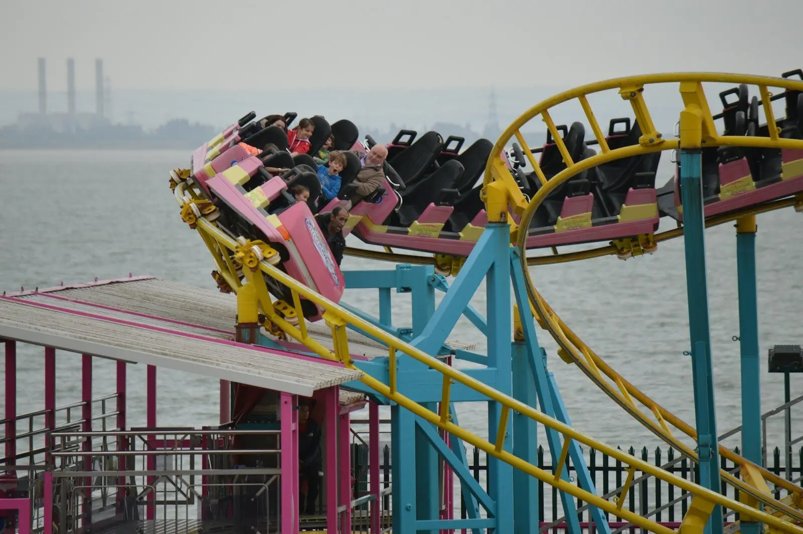 people riding on red boat during daytime
