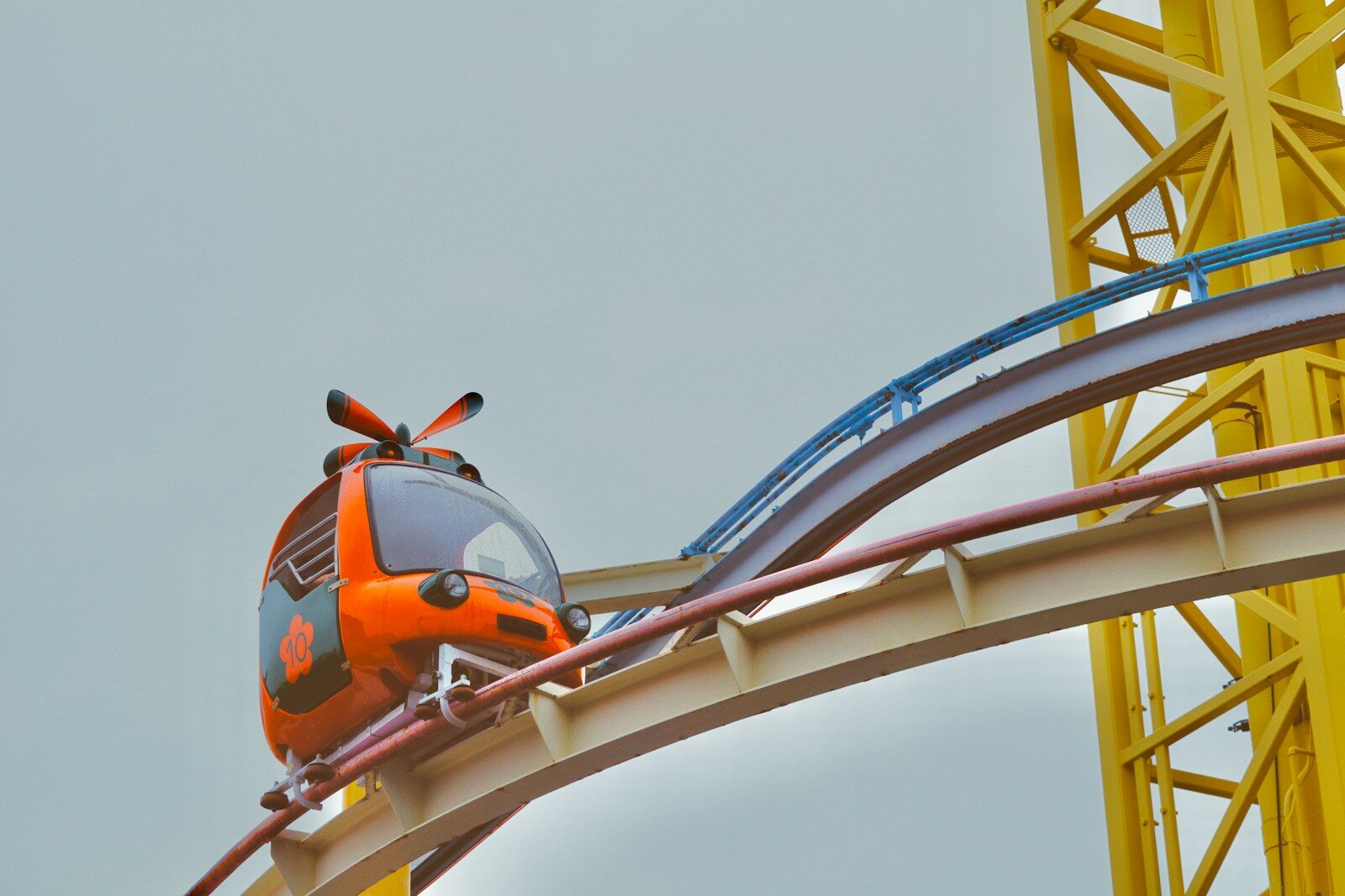 Orange roller coaster car on a track