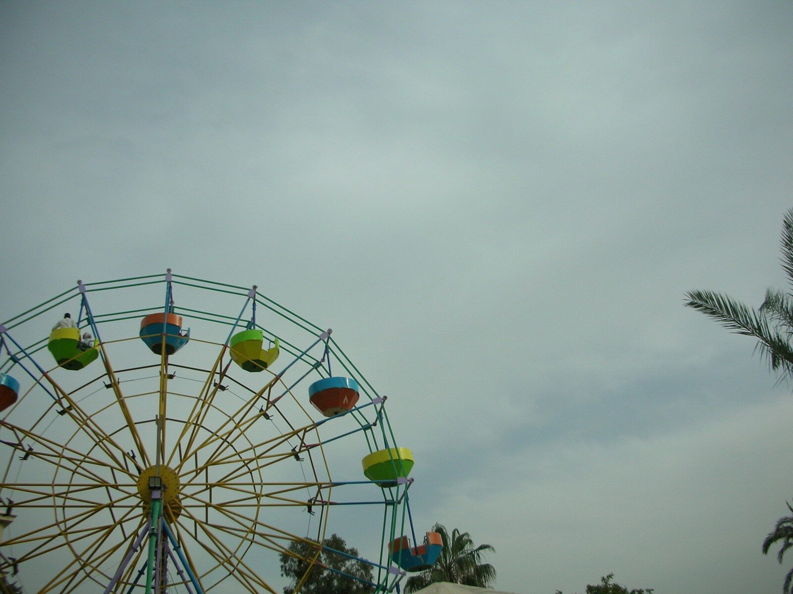 Colorful ferris wheel against a cloudy sky