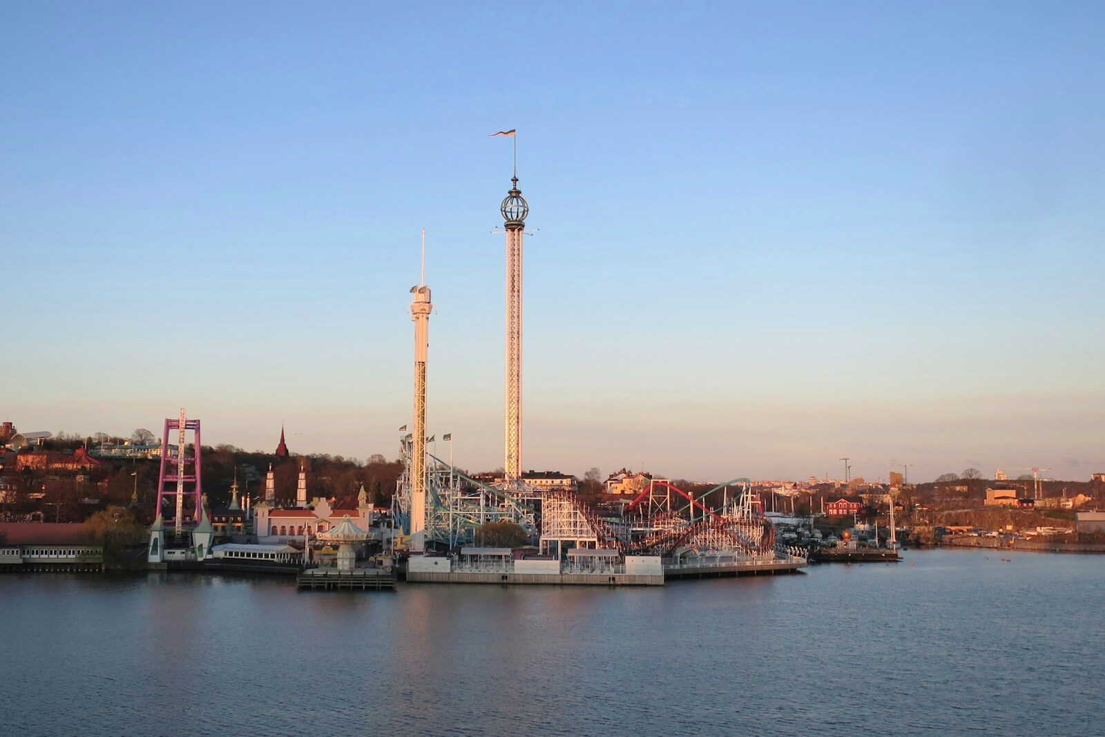 a bridge over a body of water with a tower in the background