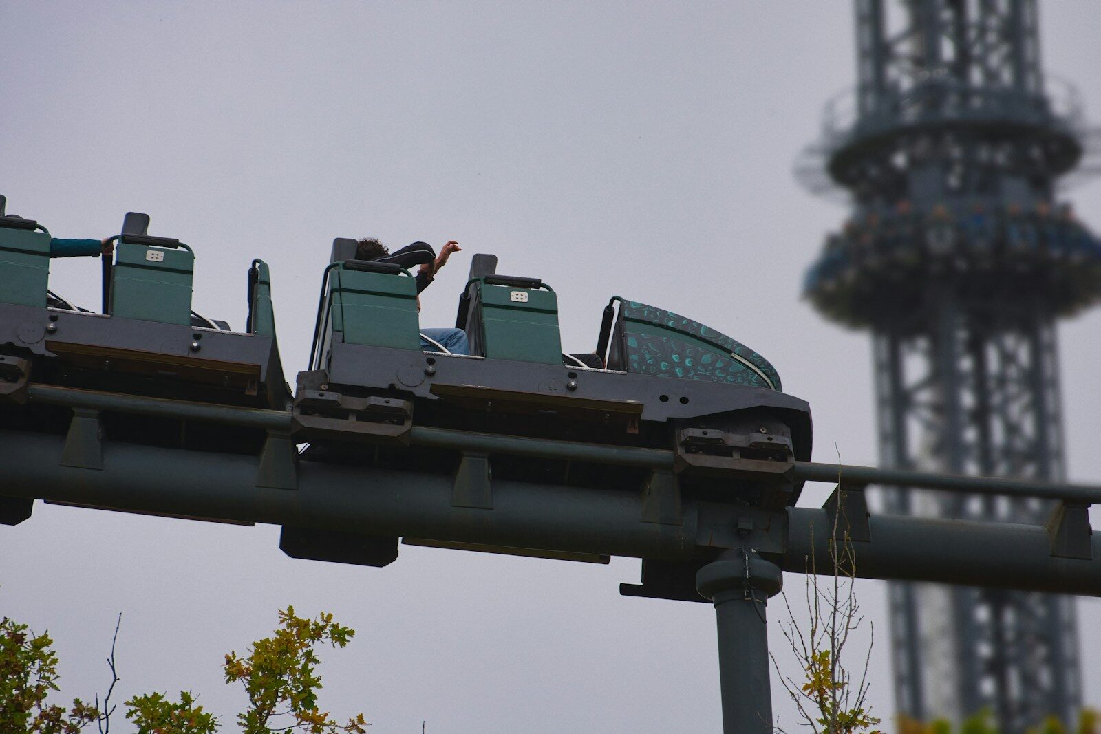 Roller coaster train on track with tower background