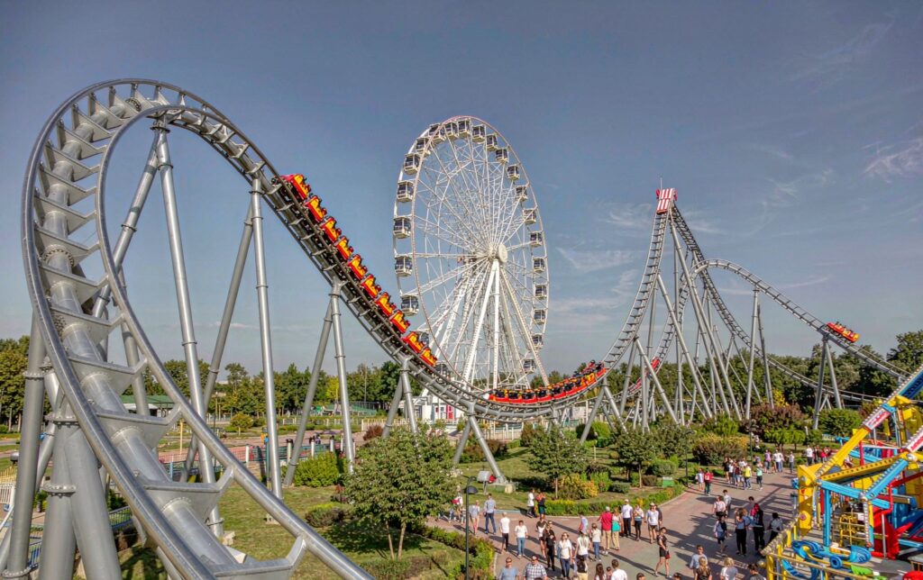 Theme park manufacturers assembling a steel roller coaster track on site