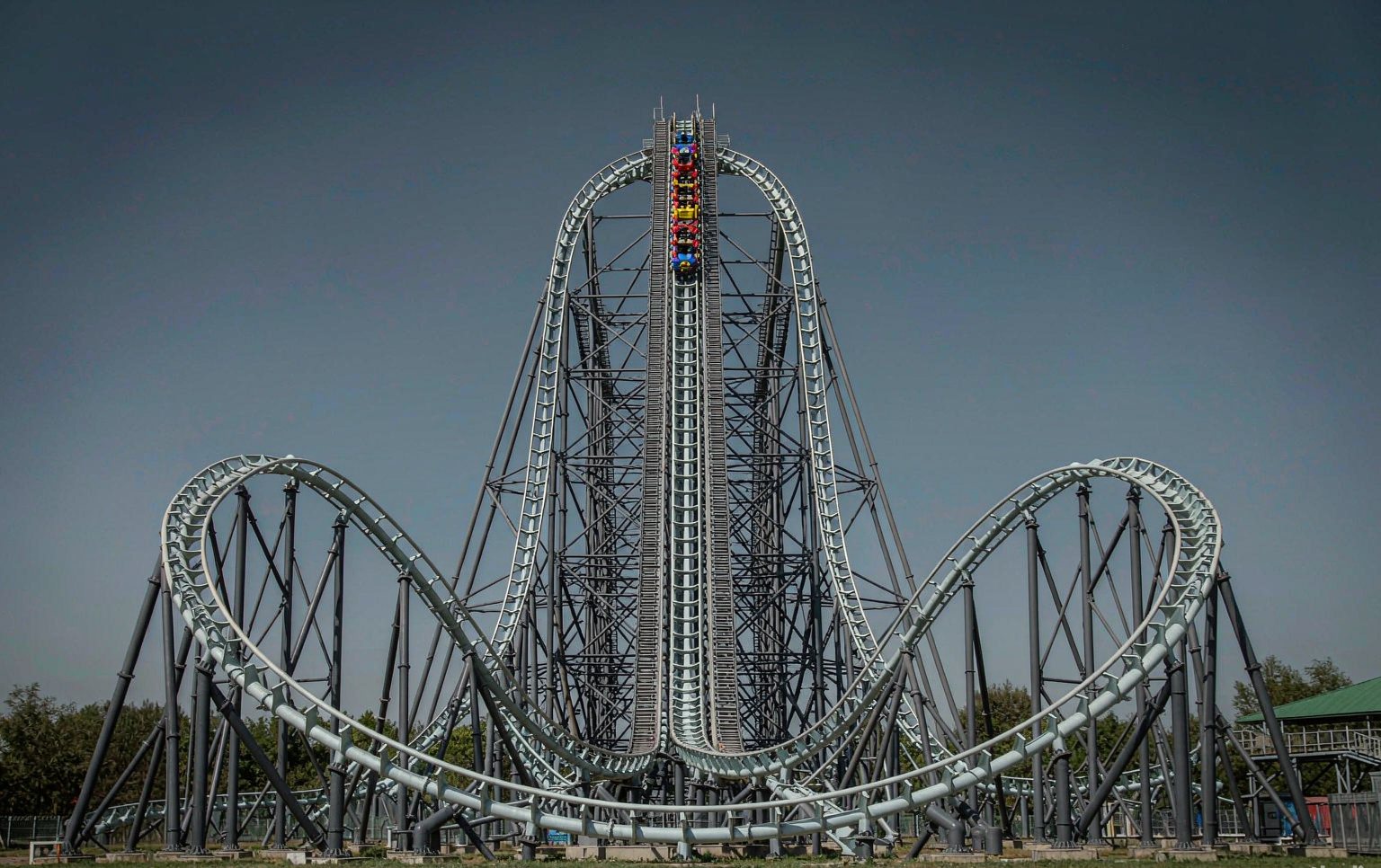 Family roller coaster for sale with blue steel track and a boarding station at a theme park