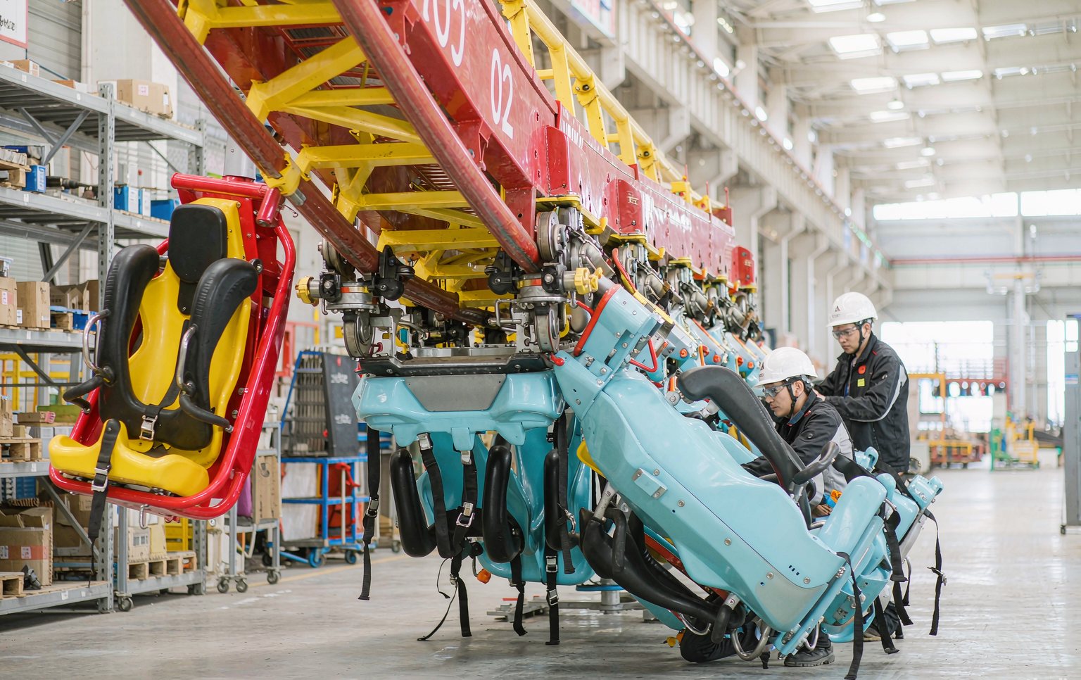 fairground ride manufacturers inspecting a roller coaster during factory testing