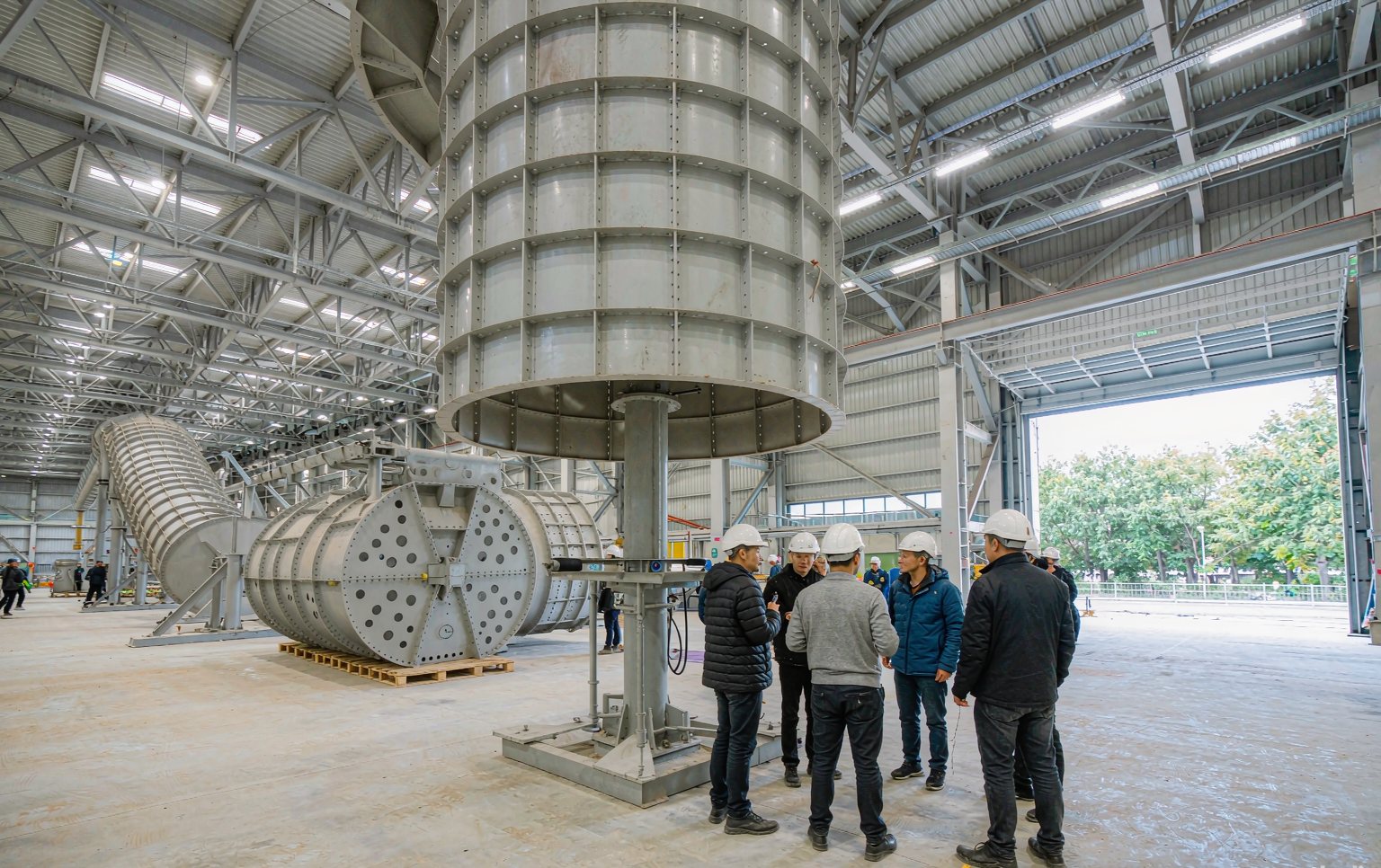 Procurement team reviewing drawings with an amusement ride supplier at a factory