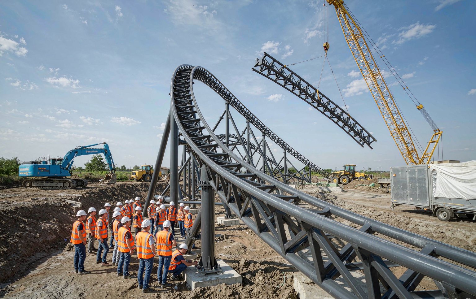 Theme park manufacturers assembling a steel roller coaster track on site