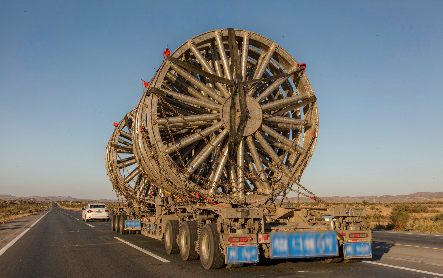 Installation crew assembling the rim sections of a 66 m ferris wheel for sale at a coastal theme park