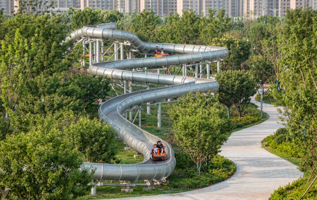 compact 400m mountain coaster on a small hill beside a green park