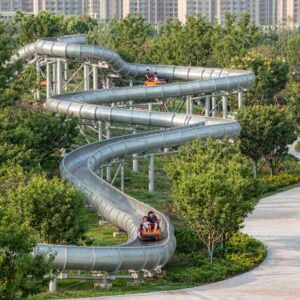 compact 400m mountain coaster on a small hill beside a green park