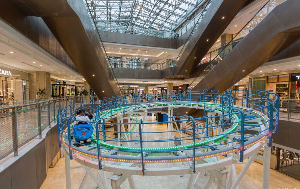 indoor mountain coaster with LED lighting inside a large shopping mall atrium