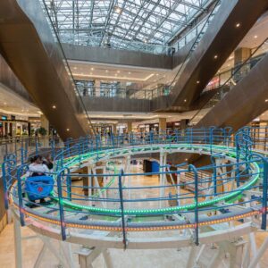 indoor mountain coaster with LED lighting inside a large shopping mall atrium